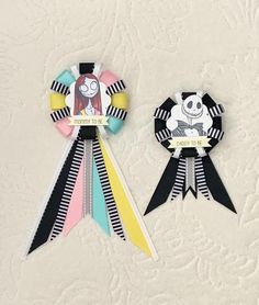 two ribbons with cartoon characters on them sitting next to each other in front of a white background