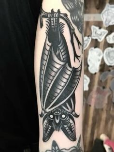 a black and white tattoo on the arm of a person with a snake in it