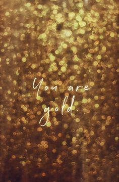 the words you are gold written in white ink