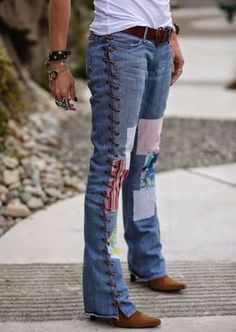 a man in white shirt and jeans standing on sidewalk