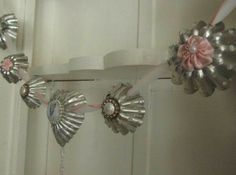 some silver and pink decorations hanging from a door