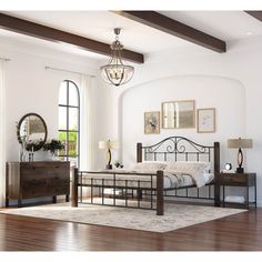 a bedroom with white walls and wooden floors