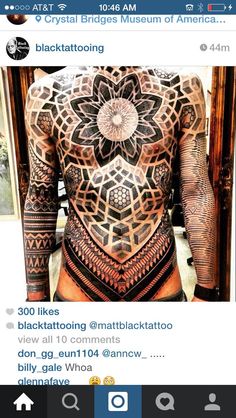 the back of a man's body with tattoos on his stomach and chest,