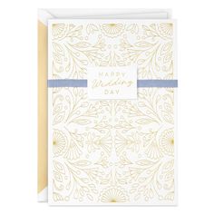 a white and gold greeting card with the words happy wedding day on it's front