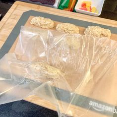 cookies are wrapped in plastic on a cutting board