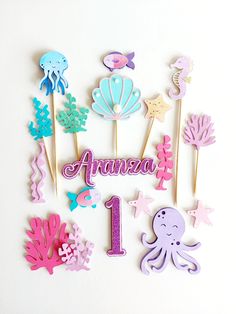 there are some cupcake toppers that say anima and have sea animals on them