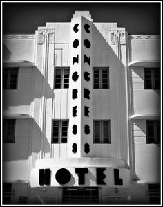 a black and white photo of a building with the word hotel on it's side