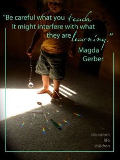 a little boy standing in the middle of a room with a light shining on him