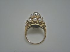 "For Sale is: (1) H077 Stunning Coctail (19) Pearl Ring in 14k Yellow Gold Please Read ENTIRE DESCRIPTION BEFORE PURCHASING This beautiful ring features cocktail ring with multiple (19) pearls in different size. Ring stamped 14k and it is size 5.5 This is a very elegant ring! Cosmetic Condition: This ring is in good condition. A few minor scratches due to age. AS SEEN IN PICTURE: Specifications: *14K Yellow Gold *Cocktail Style *Pearls (12) are approx. 3.4 mm (at the bottom of the ring) *Pearls Luxury Yellow Gold Timeless Pearl Ring, Fine Jewelry Cluster Wedding Jewelry, Gold Halo Ring With Prong Setting For Formal Occasions, Formal Gold Halo Ring With Prong Setting, Elegant Multi-stone Party Rings, Elegant Multi-stone Rings For Party, Formal Heirloom 14k Gold Halo Ring, Antique 14k Gold Pearl Ring For Anniversary, Classic Marquise Jewelry For Party