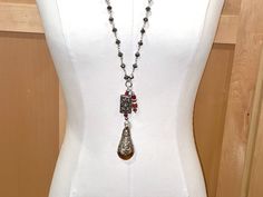 Rich, luxe, one of a kind, this unique necklace is pretty breathtaking. The chain is made of large, faceted, shiny silver PYRITE rondelles, and, without accouterments, measures 32" in length, which means you get a 16" drop. If you add the multiple pendants and accouterments at the bottom, you gain an additional 5 1/4" of wearable drop length. This lovely piece slips over the head with ease. The pendants are TIBETAN CARNELIAN, handmade by the tribespeople of Tibet. The FOCI pendant at the bottom is a fantastic 2 3/8" long and1 1/4" wide Tibetan smooth and gorgeous carnelian stone. It is capped almost 3/4" of the way down with magnificent TIBETAN STERLING SILVER which is ornately carved using a repousse technique. Above this piece is a secondary Tibetan sterling piece, a rectangular massivel Elegant Carnelian Necklace With Large Pendant, Elegant Carnelian Jewelry With Large Pendant, Silver Gemstone Long Drop Necklaces, Silver Long Drop Gemstone Necklaces, Elegant Silver Drop Necklace With Natural Stones, Silver Carnelian Bohemian Necklaces, Silver Carnelian Bohemian Necklace, Bohemian Silver Carnelian Necklaces, Silver Carnelian Necklace With Large Pendant