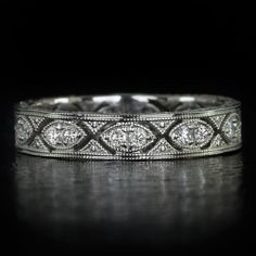 an antique diamond wedding ring on a black background