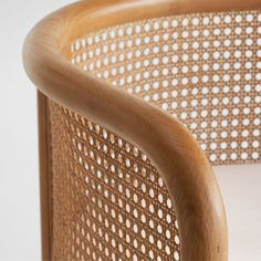 a close up of a wooden chair with white dots on the back and seat cushion