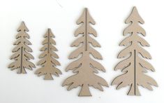 three wooden cutouts of trees on a white background