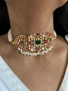 Simply a mark of royalty and elegance! You will definitely fall in love with the beautifully placed multicolored Kundan stones, One of our favorite picks for the wedding season. Do notice the beautiful pink beads in the pearl strings. Material: Copper Brass and silver mix, with gold plating Premium quality Choker Necklace Dimensions: Weight: 45 grams. Closure Type: Premium Adjustable Dori Earring Dimensions (Per Pair): Weight: 12 grams Length: 4.5 cm Width: 2 cm Closure Type: Push Back Closure with Extra Support Clip at the Back. Pearl Gemstone Jewelry For Party, Elegant Multi-stone Pearl Necklace For Gift, Elegant Multi-stone Jewelry For Festivals, Elegant Multi-stone Pearl Necklace Gift, White Pearl Jeweled Jewelry, White Jeweled Pearl Jewelry, Party Jewelry With Pearl And Gemstone, Festive Multicolor Pearl Drop Jewelry, Fusion Multi-stone Pink Jewelry