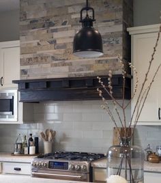 a kitchen with a stove top oven next to a microwave