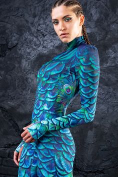 If you're lookin' for your next festival fit, you've come to the right place. The Mystic Peacock Costume is an absolute showstopper. This piece is made from a high quality stretchy and breathable Lycra fabric, printed with exceptional graphics as alwayz. The design features a body con fit, padded shoulders, long sleeve Bodysuit Festival Outfit, Dance Bodysuit, Rave Costume, Outfit Rave, Festival Outfits Women