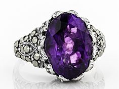 4.89ct oval African amethyst with round marcasite rhodium over sterling silver ring. Measures approximately .81"L x .59"W. Not sizeable. Purple Oval Jewelry With Diamond Accents, Silver Amethyst Ring With Diamond Accents, Formal Marcasite Gemstone Jewelry, Silver Oval Amethyst Ring With Gemstone Accents, Oval Silver Amethyst Ring With Gemstone Accents, Oval Marcasite Jewelry For Formal Occasions, Formal Oval Marcasite Jewelry, Silver Marcasite Jewelry With Oval Shape, Sterling Silver Amethyst Ring With Diamond Accents