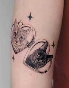 a cat and a kitten in a heart tattoo on the left arm with stars around it