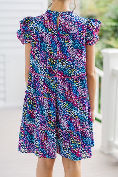 Get ready to dazzle in this ruffled babydoll dress, featuring a vibrant spotted abstract print that's bound to make heads turn. The playful ruffles and colorful print blend seamlessly, creating a look that's both stylish and unique. Whether you're conquering the workday or embarking on a leisurely outing, this dress guarantees to keep your style game on point. Round neckline Button keyhole back Ruffled cap sleeves Pleated detailing Tiered babydoll cut Spotted abstract print No stretch Cindy is w Playful Multicolor Tiered Dress, Playful Multicolor Floral Print Dress, Playful Multicolor Print Short Sleeve Dress, Multicolor Tiered Ruffle Dress, Playful Short Sleeve Multicolor Print Dress, Playful Multicolor Ruffle Dresses, Multicolor Mini Dress With Ruffles, Playful Multicolor Ruffled Dresses, Playful Multicolor Short Sleeve Mini Dress