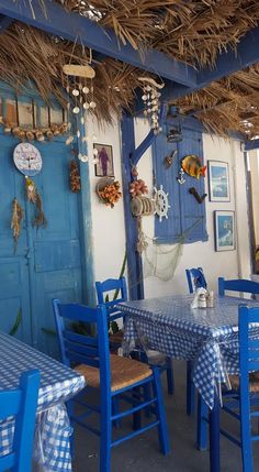 a blue and white restaurant with tables and chairs