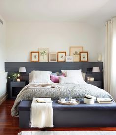 a bedroom with a large bed and pictures on the wall