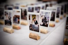 there are many pictures on the table with wine corks in front of each other