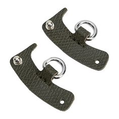 two black leather handles with metal rings on them