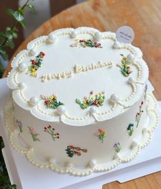 a decorated cake sitting on top of a wooden table