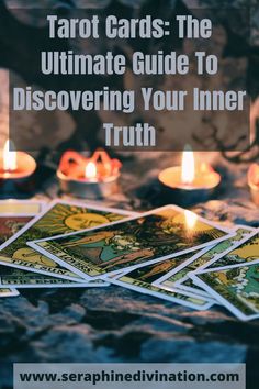 tarot cards sitting on top of a table with candles in front of it and the text tarot cards the ultimate guide to discovering your inner truth