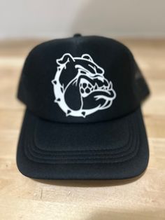 West York Bulldog trucker cap  Perfect way to show your school spirit  Don't see what you're looking for? We love to do custom orders, message me with the details!  ⭐️ Every item is made with ♥️, customized to your liking  ⭐️ NO CANCELLATIONS.... please read each listing carefully  ⭐️ Handmade items may take longer to ship, please notify me of any time constraints! ⭐️ All customized items are printed to order especially for you & are a FINAL SALE  ⭐️ Please message me with any questions before purchasing, We are here to answer any questions you might have! DELIVERY TIMES ⭐️ Although we cannot guarantee specific delivery dates, feel free to message us for other expedited shipping options. ⭐️ PLEASE PLACE ORDERS IN ENOUGH TIME FOR DELIVERY  As stated in Etsy's buyer policies (https://www.ets Black Cap For School, College Trucker Hat With Letter Print, College Trucker Cap With Letter Print, Letter Print Trucker Hat For College, One Size Fits Most Trucker Hat For College, Customizable Trucker Hat For Streetwear, Custom Logo Trucker Hat For Sports Events, Customizable Black Trucker Hat For Streetwear, Customizable Trucker Baseball Cap For Streetwear