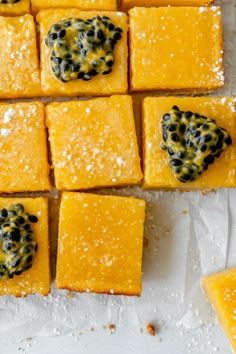 several square pieces of yellow cake with blueberries on top