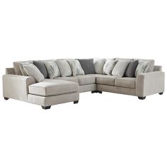 a large sectional couch with pillows on the top and bottom corner, sitting in front of a white background