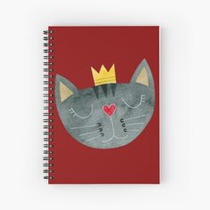 a spiral notebook with a cat wearing a crown on it's head and eyes closed