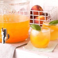 two glasses filled with orange juice next to each other