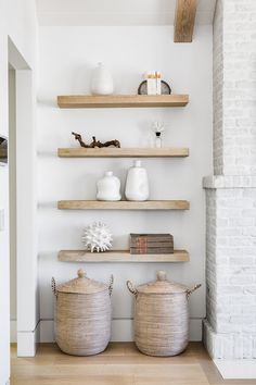 some shelves with baskets and vases on them