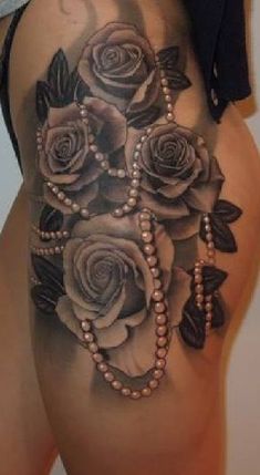 a woman's stomach with roses and pearls on it