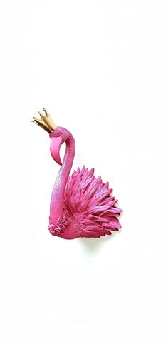 a pink flamingo sculpture sitting on top of a white surface