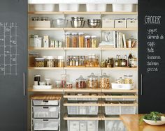 the pantry is stocked with lots of food and storage bins, including containers for storing items