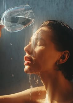 a woman drinking water from a faucet with her face covered in soapy bubbles