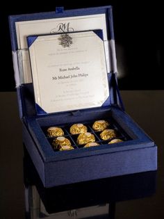 an open blue box with some gold cookies in it