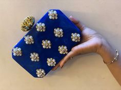 💥 Overview: Discover the perfect finishing touch for your wedding ensemble with our Handmade Bridal Acrylic Clutch. Adorned with luxurious pearl and diamond accents, this clutch combines sophistication with modern trends to make your special day unforgettable. 💥 Key Features: ● Handcrafted Excellence: Each clutch is carefully handmade, ensuring a unique and high-quality accessory tailored for your wedding. ● Luxurious Detailing: Embellished with exquisite pearl and diamond work, adding a touch Acrylic Clutch, Bridal Bag, Clutches For Women, Wedding Clutch, Wedding Favor Bags, Modern Bridal, Gift Hampers, Favor Bags, Halloween Gift