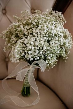 a bouquet of baby's breath sitting on top of a couch