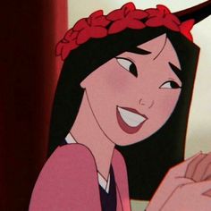 an animated image of a woman with long black hair wearing a pink shirt and flowered headband