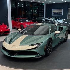 several different colored sports cars in a showroom