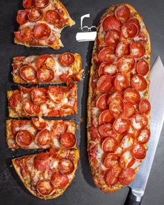 slices of pizza with pepperoni and cheese are on a cutting board next to a knife