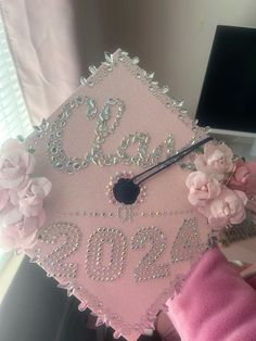 a pink graduation cap with flowers on it