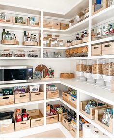 an organized pantry with white shelves and wooden bins filled with food items, including cereal