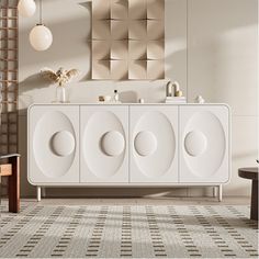 a white cabinet with four circles on the front and two mirrors above it, against a beige wall