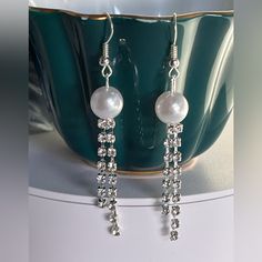 Rhinestone Faux Pearl Earrings. A Cascade Of Rhinestones And Pearls For Classy Holiday Looks. Thanks For Visiting Our Shop Reasonable Offers Always Welcomed! Please Look Carefully At All Pictures/Video As They Are Part Of The Description And Any Markings On New Jewelry Is A Manufacture Defect. Measurements Are Appropriate. Colors Might Look Slightly Different As They Vary On Different Monitors. T1320-2 Pb1223 43064 Crystal Dangle Pearl Earrings For Party, White Dangle Earrings With Bling, White Pearl Earrings With Rhinestones For Party, White Rhinestone Dangle Crystal Earrings, White Dangle Crystal Earrings With Rhinestones, White Rhinestone Dangle Earrings, White Dangle Earrings With Rhinestones, Pearl Silver Earrings, Silver Pearl Earrings