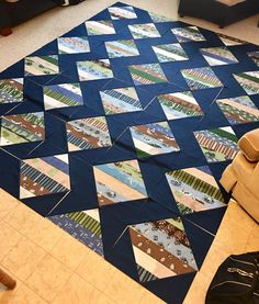 a living room with a large blue rug on the floor next to a couch and chair